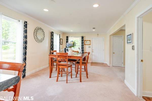 The living room has built in book cases and beautiful fireplace.