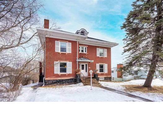 Individual bedrooms in large brick house