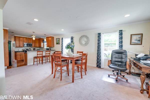 The living room has built in book cases and beautiful fireplace.