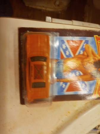 A nice george strait collectable painting and dukes of hazzard car